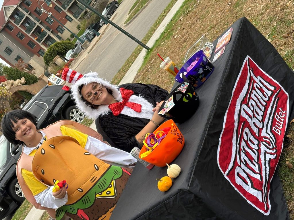 Volunteers in costume at a treat table