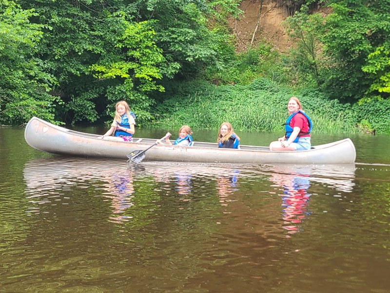 Campers paddling a canoe