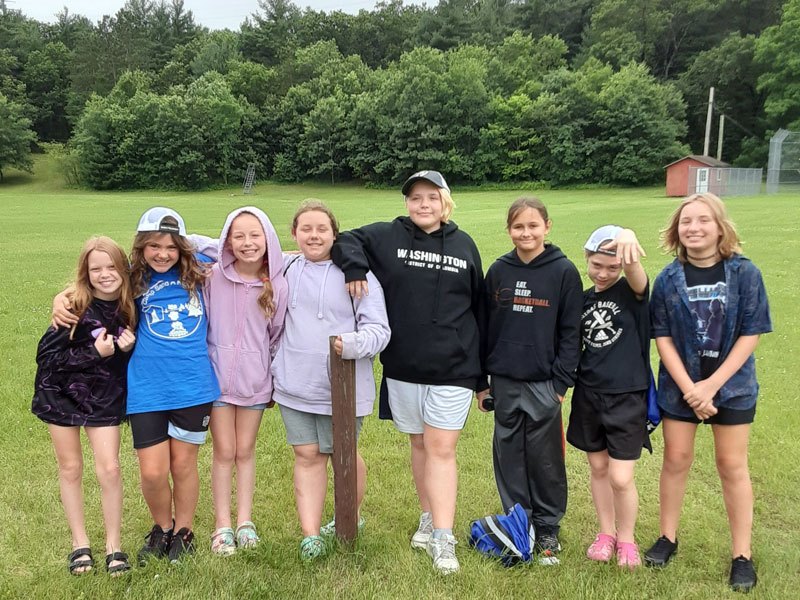 A group of campers posing in a field