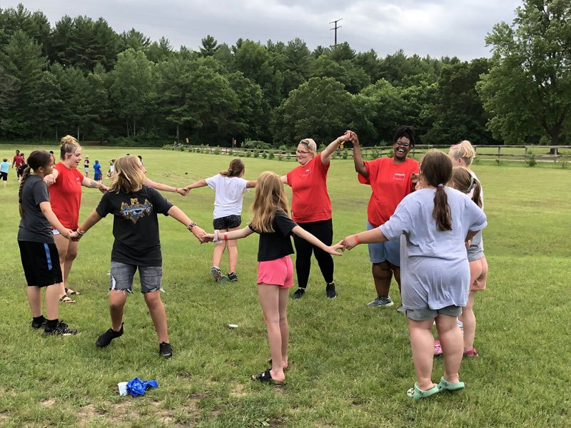 Campers holding hands in a circle game